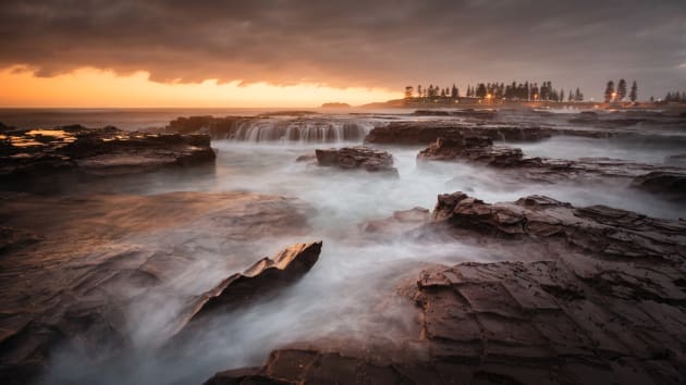 Kiama, NSW. There are many great rock shelves to photograph around Kiama, and this spot at Pheasant Point is no exception. I noticed the sun reflecting off this rock and tried to put it into the foreground of a composition. In the end I used it to help lead the eye into the scene, where it is pointing to the township of Kiama in the distance. Canon 5D Mark III, Canon 17-40 f/4L, 4 sec @ f/8, ISO 160, tripod