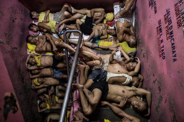 Inmates sleep in the stairwell of a crowded jail, Manilla.