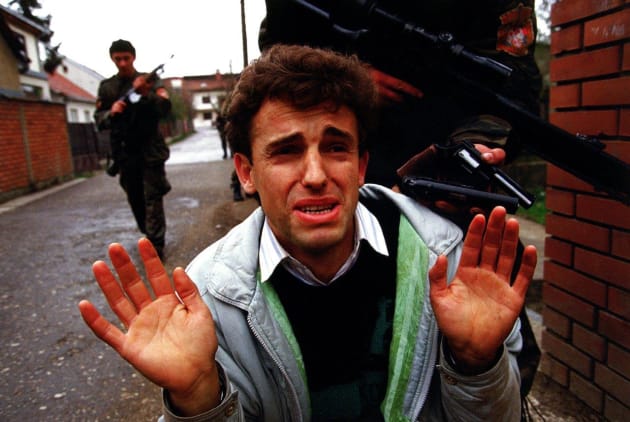 Harush Ziberi, a Muslim, begs for his life from the Tigers, the Serbian paramilitary unit, led by warlord Arkan during the first battle for the war in Bosnia. He was later killed, his body found in a mass grave. © Ron Haviv/VII Photo.