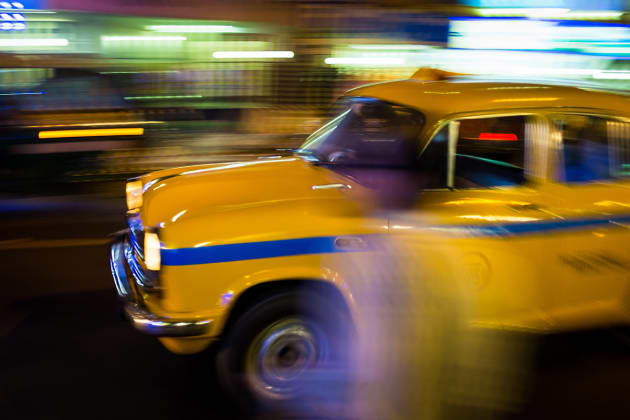 The iconic yellow cabs of Kolkata can be found on almost every street. Due to the number of taxis on the roads I was able to experiment with some long exposure panning techniques. Fujifilm X100S, 23mm lens @ 23mm, 1/15s @ f11, ISO 200, handheld. Contrast, curves and levels adjustment, sharpening in Photoshop CC. Photo © Drew Hopper.