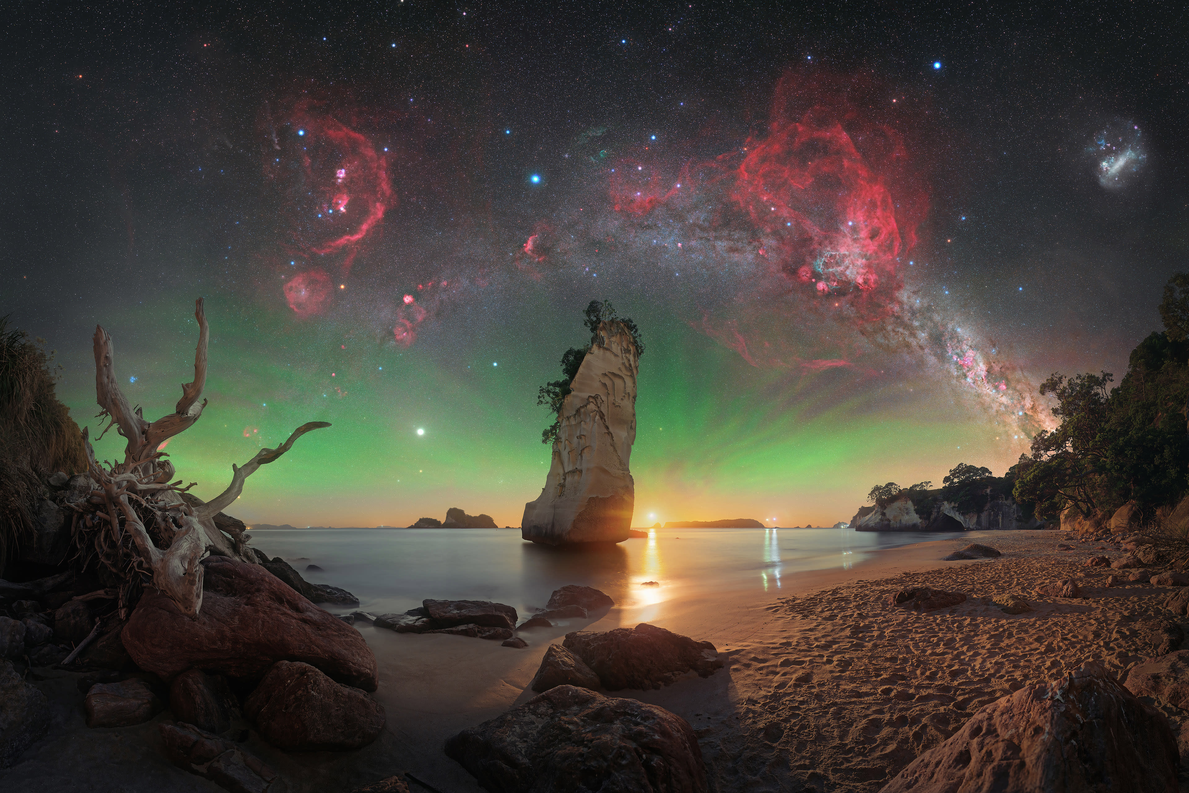 Te Hoho Rock Moonrise © Evan McKay (Aotearoa/New Zealand). On this particular night, Evan McKay had only a small window to capture the sky before the Moon started to rise. McKay polar-aligned his mount during twilight and then began shooting the sky panorama from this location. The moonlight provided the best of both worlds and did a fantastic job of lighting up the foreground. To enhance the sky, McKay captured a separate panorama using a dual narrowband filter and blended it in to bring out the nebulae.Taken with a Nikon Z 6a camera, Sky-Watcher EQ6-R Pro mount, Move Shoot Move Nomad star tracker, Sigma 40 mm Art lens, Optolong L-Para filter, 40 mm, Foreground: f/2.8, ISO 800, 30-second exposure; Sky: f/2, ISO 1600, multiple 15-second RGB exposures, multiple 2-minute exposures with filter.
