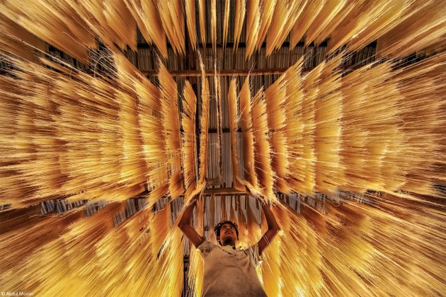 Fujifilm Award for Innovation, Abdul Momin, Bangladesh. 'Making Rice Noodles'. A worker is inspecting rice noodles if they got dried rightly or not.