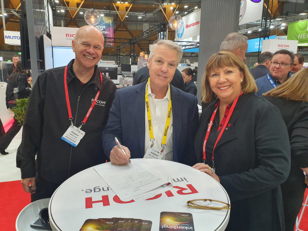 Done deal: Walter Kuhn (centre) with Simon Lane (left) and Roberta Van Trier, Ricoh