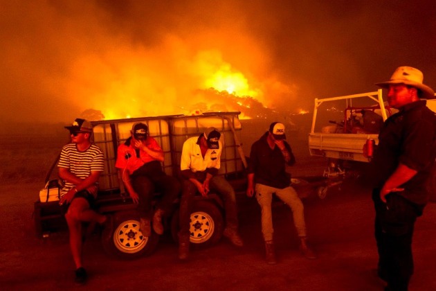 © Daniel Berehulak. Farmers, friends, and neighbours ready their water-laden trucks in order to battle approaching running fires to defend cattle on Bredbo Station, NSW, on 1 February, 2020.