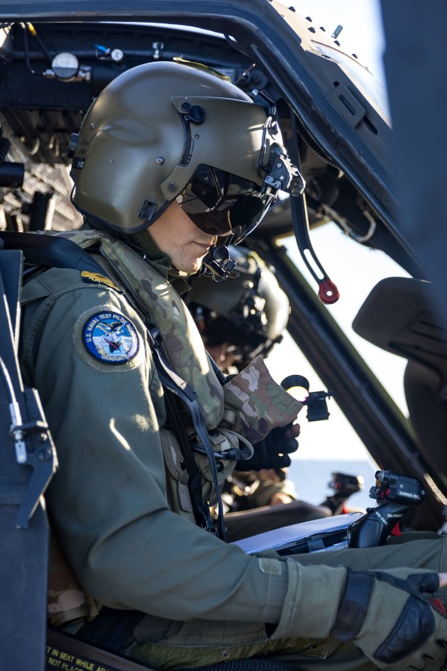 RAN test pilot Lieutenant Peter Jacobs conducts pre-flight checks on an Australian Army UH-60M Black Hawk. 
Credit: Defence
