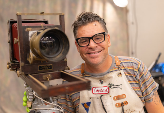 Conrad at Viva Las Vegas Festival with his travelling studio / lab. After pouring the liquid onto the &lsquo;sheet&rsquo; it goes into a dark slide then to the back of the camera. Image: Tim Levy