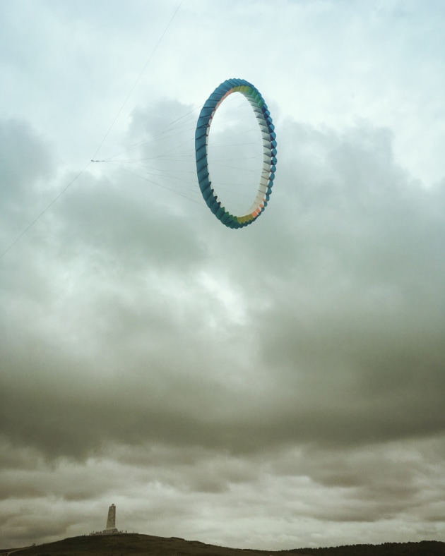 1st Place – Other: Sky Portal by Amy Nelson, United States
“I took this photo at the 39th Annual Wright Kite Festival in Kill Devil Hills, NC, where 30-100 foot kites were on display amidst clouds and drizzle.”
Location: Wright Brothers National Park, North Carolina. Shot on iPhone SE