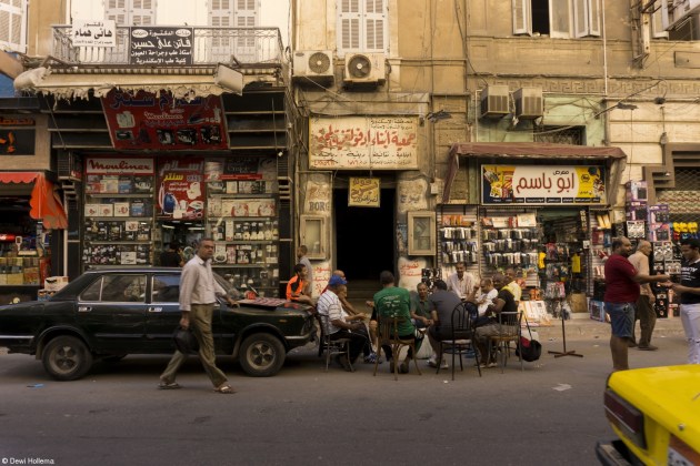 Young - 15 - 17, Dewi Hollema, Egypt. 'Spill the Tea'. Men gather round on the side of the street in old Alexandria to share the local gossip with a cup of black sweet tea and snacks. This is a common sight in Egypt where their national drink is enjoyed throughout the day: tea شاي.