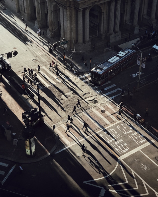 2nd Place – Sunset: Chasing Light by Cocu Lui, United States
“This photo was taken in the Financial District of San Francisco before sunset. I was fascinated by the street scene with busy commuters, low angle lights and long shadows of people.” 
Location: San Francisco, United States. Shot on iPhone 7 Plus