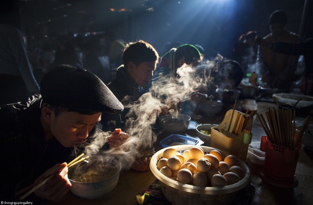 Food at the Table, Thong Nguyen, Vietnam. 'Breakfast at Weekly Market'. People enjoy their Pho (beef of chicken noodle) for breakfast at a local weekly market.