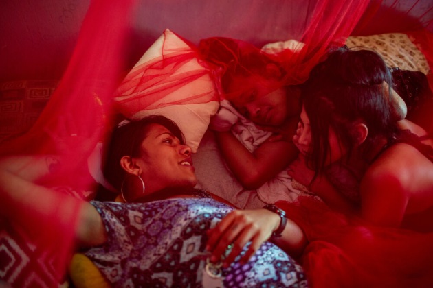 © Danielle Villasana, from the project, Abre Camino. Left to right: Iris Samantha Hilton, Alexa Smith, and Escarle Lovely talk together in Escarle's room in San Pedro Sula, Honduras, on March 29, 2019.