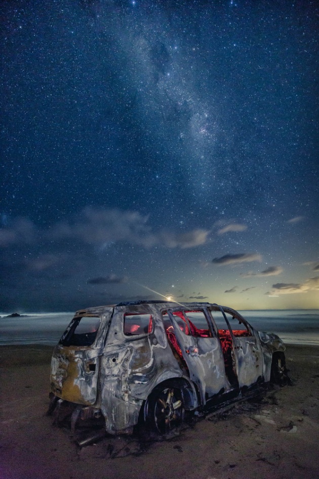 An burnt abandoned car on Birrubi Beach in Anna Bay, NSW, Australia.