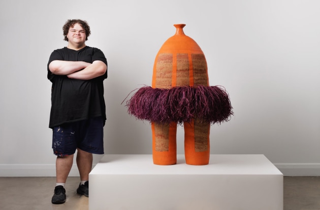 alfred-lowe-with-his-work-you-and-me-us-never-part-i-2025-courtesy-the-artist-and-apy-art-centre-collective.-photo-heyandy-1.jpg