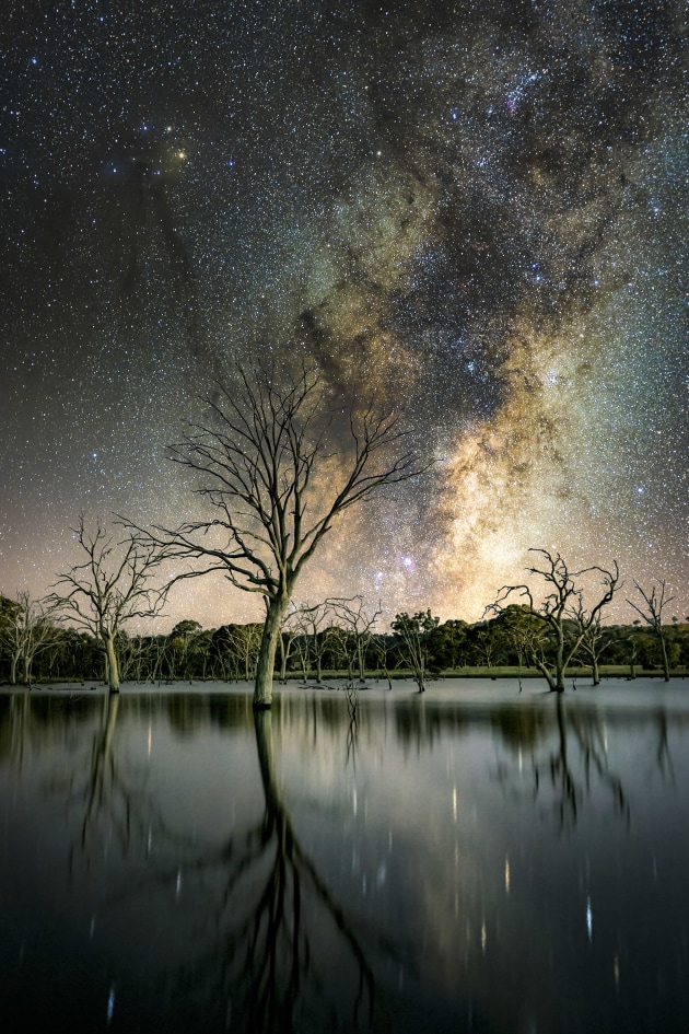 The Milky Way core emerges above Mulligans Flat, painting a surreal reflection across the quiet waters of the reserve. Canon 5D Mark IV, Sigma 35mm Art f1.4 lens. Sky: 2m @ f2.5, ISO 800, foreground: 30s @ f2.8, ISO 1000.