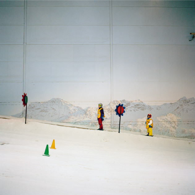 © Olivia Arthur. Kids at Ski Dubai, Dubai. U.A.E. 2013.
“One of the more surreal experiences I’ve had was a visit to Ski Dubai, a large indoor ski slope with sub-zero temperatures and real snow. You take a lift up to the top of the nearly half-kilometer long slope and halfway down you can stop at a little wooden hut and have a hot drink or snack. Standing outside with my coffee, under a gas-heater, in what is essentially a giant freezer in a desert, I couldn't help thinking about the crazy lengths we go to entertain ourselves.”