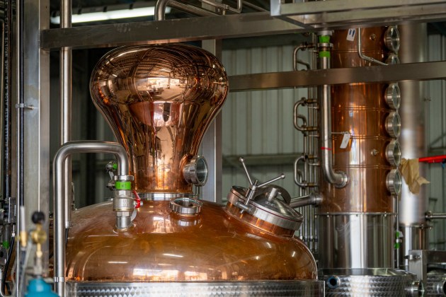 Act of Treason's four stills feature energy-saving sub cooler, a custom-designed ultra-small batch still, gravity-fed water preservation, and double copper pot distillation for sustainability and spirit quality.