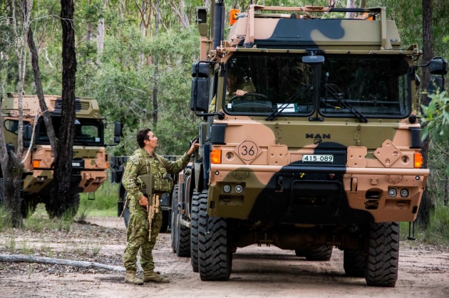 A soldier talks to a HX77 operator prior to a scenario-based field deployment activity during the Exercise Neptune Squadron 18 at Greenbank Training Area. (Defence)