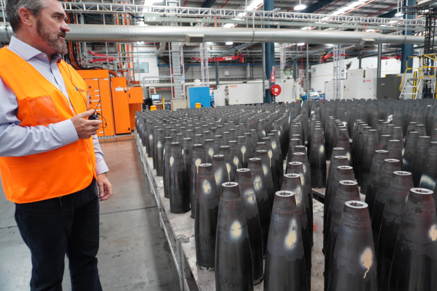 Maryborough plant manager Jeff Crabtree with 155mm artillery shells part way through the production process. 
Credit: Max Blenkin