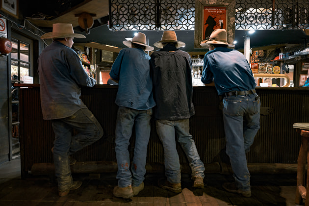 Local farmers Zak Single, Conner Johnston, Lehman Laverty and Angus Johnston standing at the bar of The Pub With No Beer, Taylors Arm, NSW Australia. Image courtesy Australian Geographic.