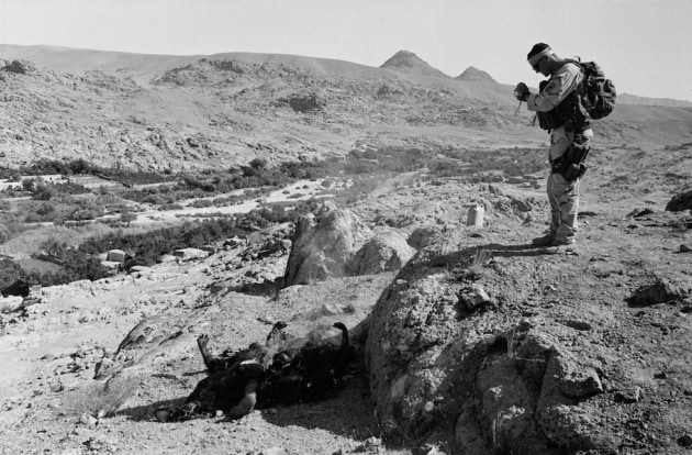 © Stephen Dupont. 2007 W. Eugene Smith Grant in Humanistic Photography recipient. 
US forces of 1st Battalion, 508th Infantry Regiment of the 173rd Airborne Brigade burn the bodies of two Taliban dead during operations to find Taliban in Gonbaz village in Shawali-Kot in Kandahar Province, October 1st 2005.