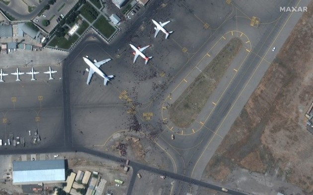 A satellite shot of crowds converging at Kabul Airport on Monday as the city fell to the Taliban. (Maxar Technologies)