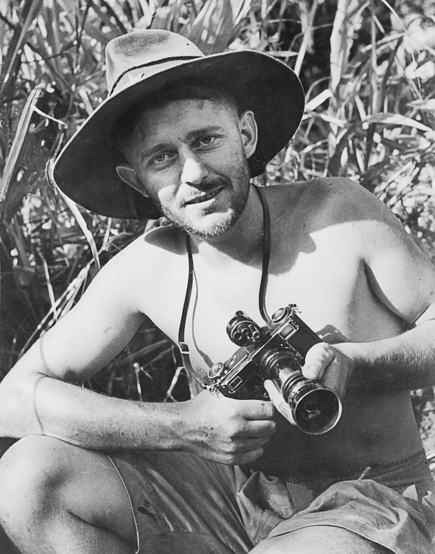 Combat photographer George Silk, near Gona, December, 1942, with his Zeiss Contax. Image: Australian War Memorial, 013757