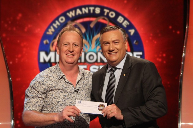 $20k winner: Brad Tyler (left) accepts the cheque from Eddie McGuire.