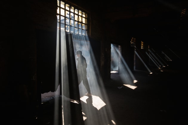 © Jędrzej Nowicki, winner of the Canon Award for Potential, 2019. Toxic smoke fills abandoned warehouses near Belgrade’s Central Railway Station. Due to lack of wood refugees used plastic bags, bottles or even shoes to keep the fire going as nights were very cold. Serbia, 2018. From the series, Paradise beaten out with a stick.