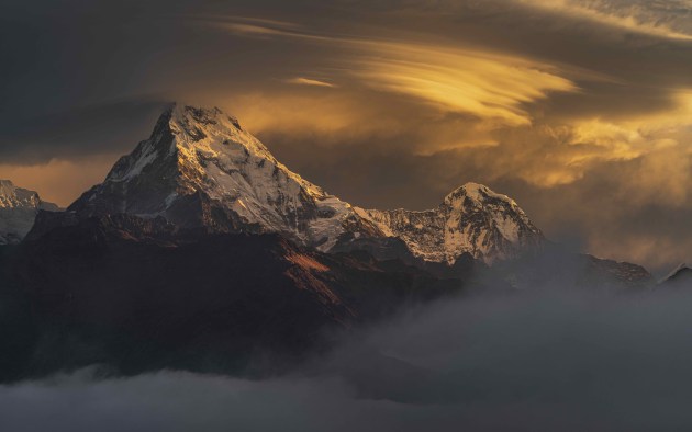 © Jesse Little. Golden Glow - Annapurna South, Nepal. "Arriving at our final sunrise location we were disappointed to find morning fog had cut visibility to zero. As we were starting to joke about the anti-climatic end to our incredible 18 day journey, the clouds lifted allowing the gorgeous golden morning light through beaming onto Annapurna South."