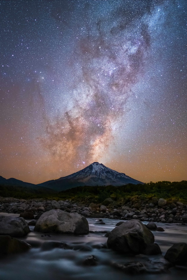 © Laurie Winter. Mt Taranaki Eruption. The milky way rises behind Mt Taranaki on a freezing May evening. "The first photo I took after being in lock-down or restricted locally for over two months. Nothing like this display of nature to realise how lucky we are. 8 photos stacked."