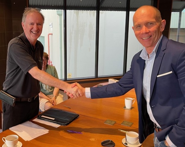 Done deal: Simon Pugh (right) shakes with Trevor Coon as QLM acquires Elna