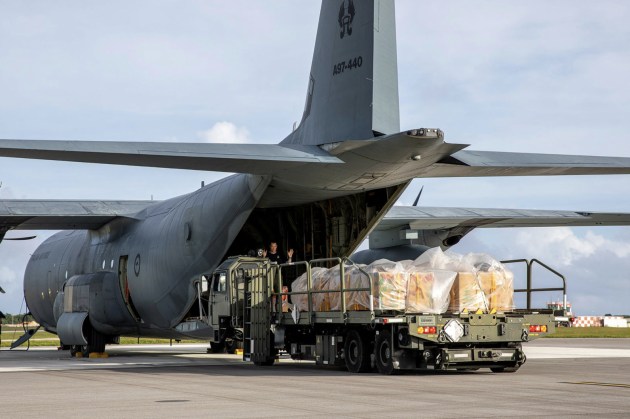 United States Air Force ground support staff load bundles built for Operation Christmas Drop 2022 onto an RAAF C-130J Hercules from No 37 Squadron. (Defence)