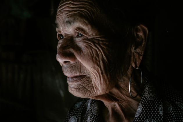 This portrait of an elderly Vietnamese woman standing in her front door was lit with natural light coming through the doorway next to her. The directional light meant that I was able to expose her face correctly and have the shadows sink into darkness. 
Fujifilm X-T2, Fujifilm 23mm f/2 lens. 1/250s @ f4, ISO 1250. Contrast, saturation and sharpening in Adobe Lightroom CC