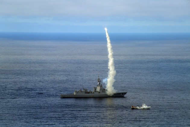 HMAS Brisbane supported by the US Naval Air Systems Command vessel SL-120. 
Credit: Defence