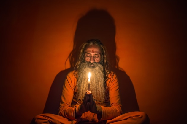 A sadhu sits inside his home holding a candle in his hands to create a surreal shadow behind his body. Compared to many underlit shots, this light gives him a sense of grandeur here. Without the under-light there would have been no shadow casting behind him. Canon 6D, Sigma 35mm f/1.4 lens. 1/80s @ f/1.4, ISO 3200. Noise reduction, contrast, saturation and white balance adjusted in Adobe Lightroom CC. 