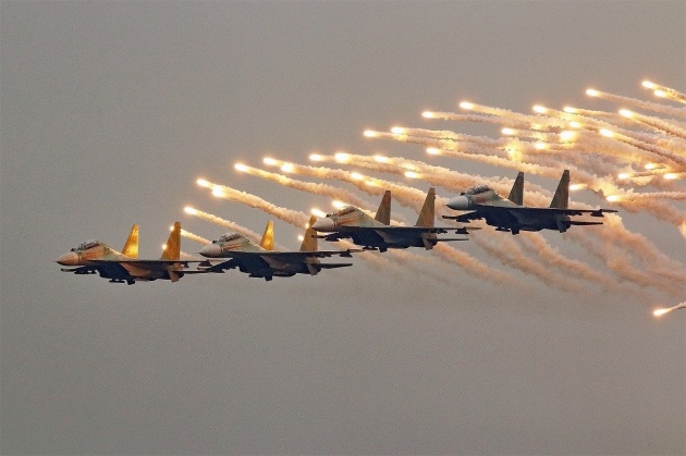 A quartet of Vietnam People's Air Force Su-30MK2Vs releasing flares during their flypast for the opening ceremony at Vietnam International Defence Expo (VIDEX) 2022. (Mike Yeo)