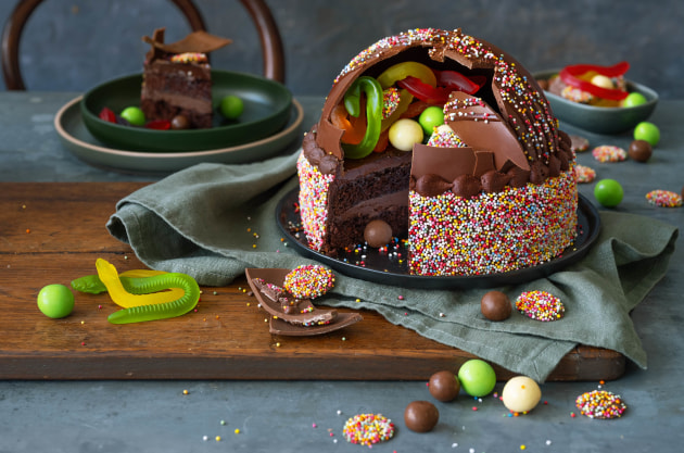 Woolworths Smash Cake ($35): featuring layers of fluffy chocolate sponge and rich buttercream, filled with hidden sweet treats in an array of rainbow colours, and topped with a milk chocolate dome and hand-finished with sprinkles.