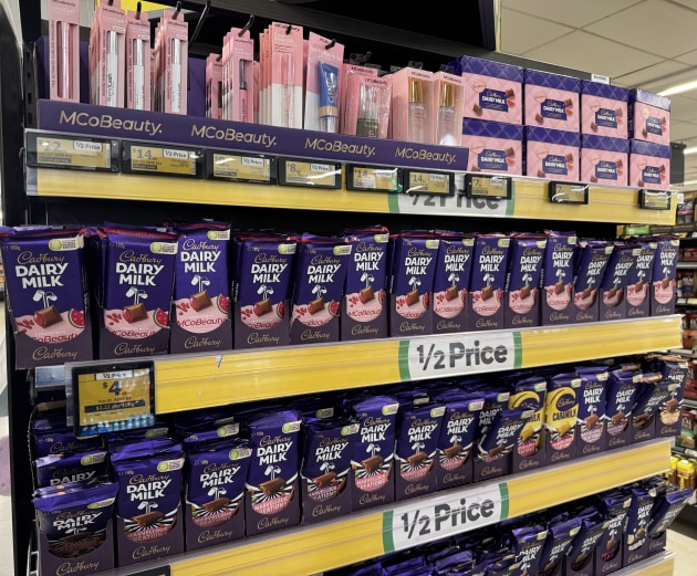 Cadbury x MCoBeauty products on display at Woolworths, showing the collaboration’s crossover between confectionery and beauty packaging.