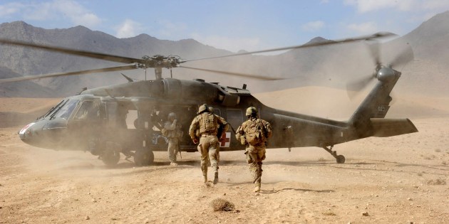 Uruzgan, Afghanistan, 2011. Escorting a casualty to a US Aero Medical Evacuation helicopter for transportation back to Tarin Kot medical facility following an Improvised Explosive Device in the Karmisan Valley.
Photo by Jo Lovell.