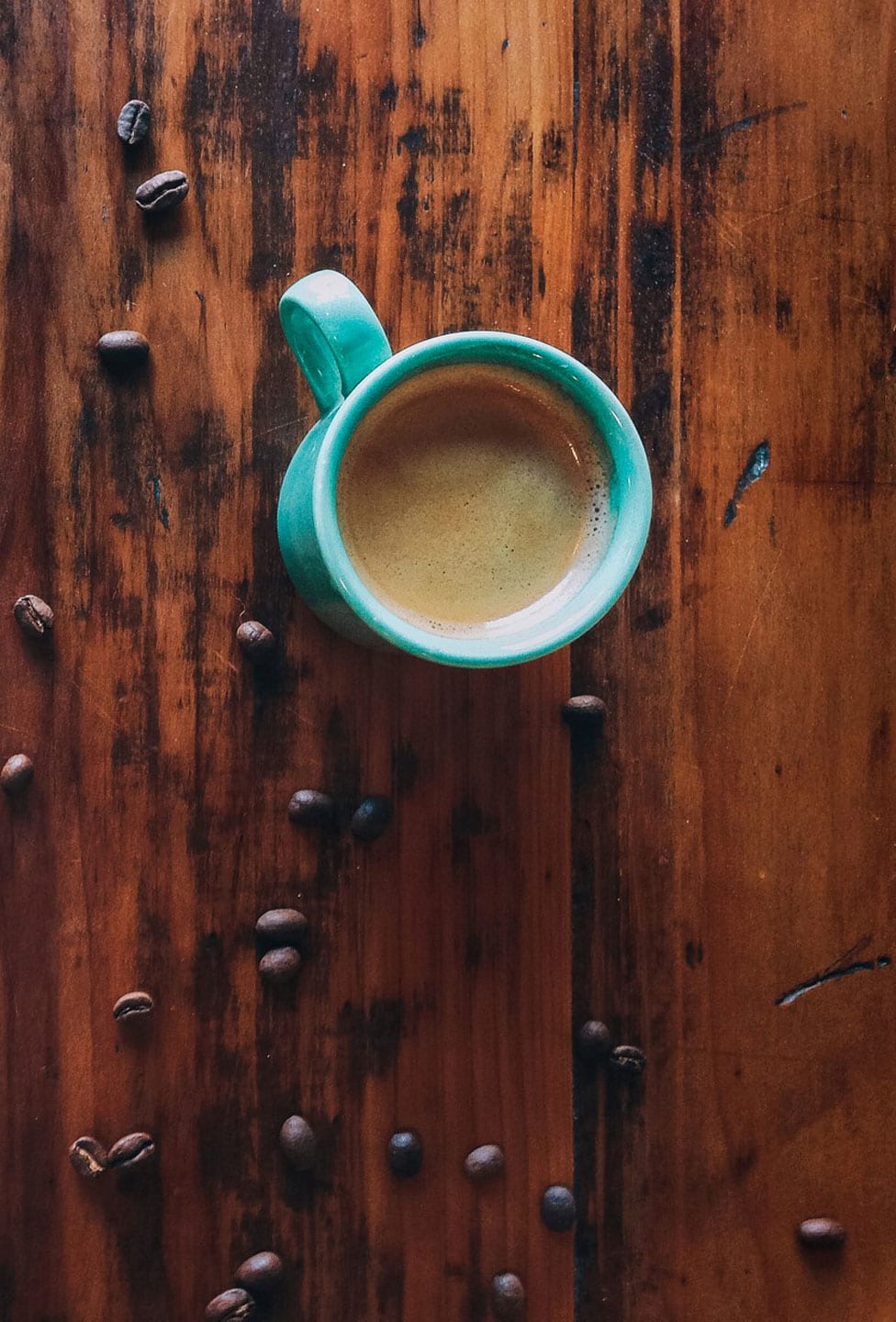 Slice of pie and coffee on hardwood table