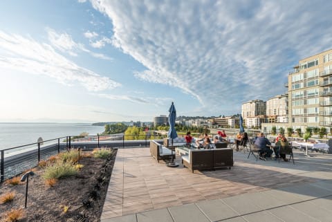 Rooftop Terrace View of Seattle Waterfront With Blue Sky and Scattered clouds at 10 Clay Apartments in Seattle, Washington