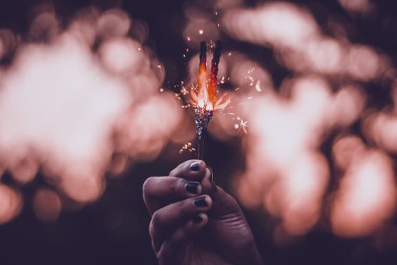 person holding sparkler at Sumida Gardens Apartments, Santa Barbara