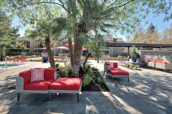 Kirker Creek l pool with seating Lounge Chairs and seating Apartments in Pittsburg, CA l Kirker Creek Apartments