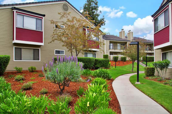 Kirker Creek l Building Apt Building w/ path Apartments in Pittsburg, CA l Kirker Creek Apartments