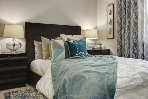 Bedroom room with bed l Kirker Creek Apartments