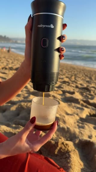 Sirviendo un espresso con la cafetera Noirpress en la playa, al atardecer