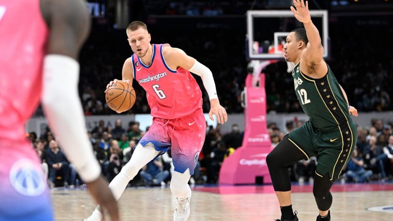 Mar 28, 2023; Washington, District of Columbia, USA; Washington Wizards center Kristaps Porzingis (6) dribbles past Boston Celtics forward Grant Williams (12) during the second half at Capital One Arena. Mandatory Credit: Brad Mills-USA TODAY Sports (NBA News)