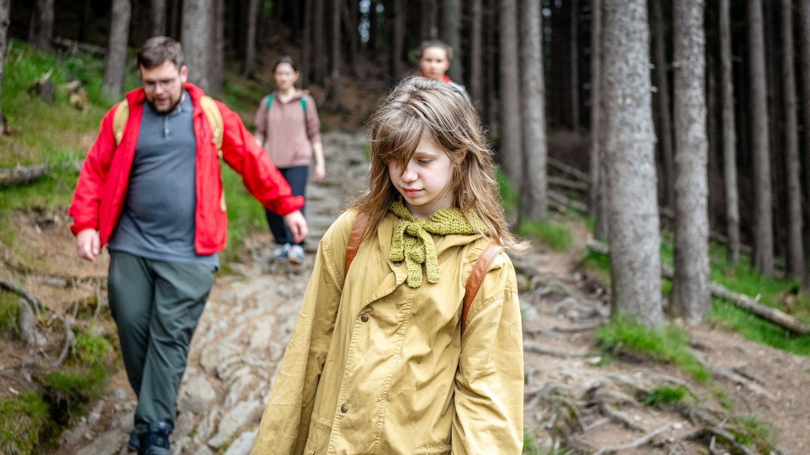Familia con hija adolescente de excursión por el bosque