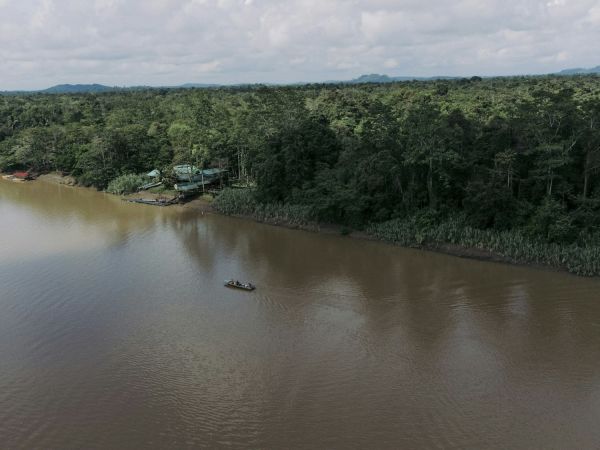 Barca navegando un río entre la selva tropical de Sabah, Borneo