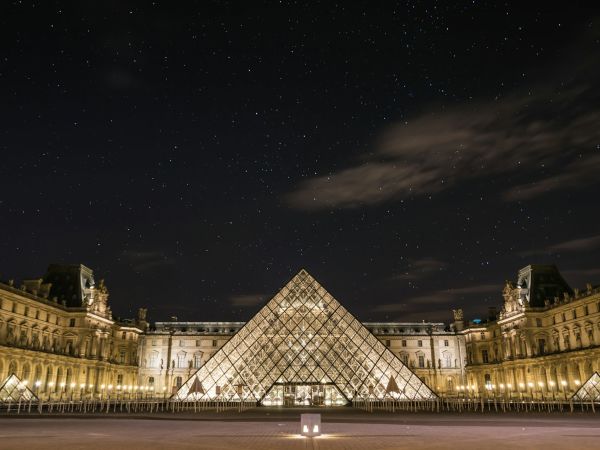 Pirámide de cristal del Louvre iluminada de noche, París
